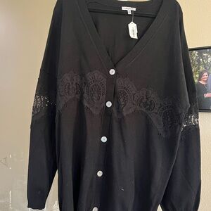 Long black sweater with lace.